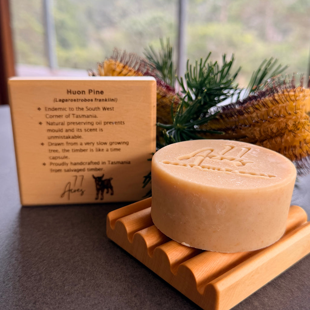 A round bar of 77 Acres Lemon Myrtle Goat Milk Soap on a reclaimed huon timber handmade soap dish. 